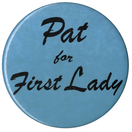 Round, light blue button with cursive text reading "Pat for First Lady". 