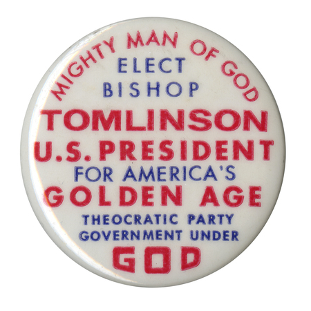Round, white button with red and blue text reading "Might Man of God Elect Bishop Tomlinson U.S. President for America's Golden Age Theocratic Party Government Under God". 