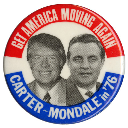 Round, white button with red and blue bands along the top and bottom edges. Centered are black and white portraits of Jimmy Carter and Walter Mondale. White text reads "GET AMERICA MOVING AGAIN CARTER-MONDALE in '76"