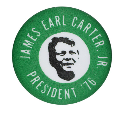 Round, green button with a white circle in the center containing a black and white portrait of Jimmy Carter. White text reads "JAMES EARL CARTER, JR. PRESIDENT '76"