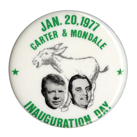 Round, white button with a black and white drawing of a donkey and black and white photographs of Jimmy Carter and Walter Mondale. Green text reads "JAN. 20, 1977 CARTER & MONDALE INAUGURATION DAY"