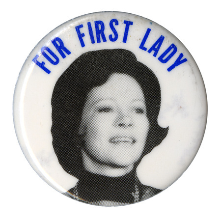 Round, white button with a black and white photograph of Rosalynn Carter. Blue text reads "FOR FIRST LADY"