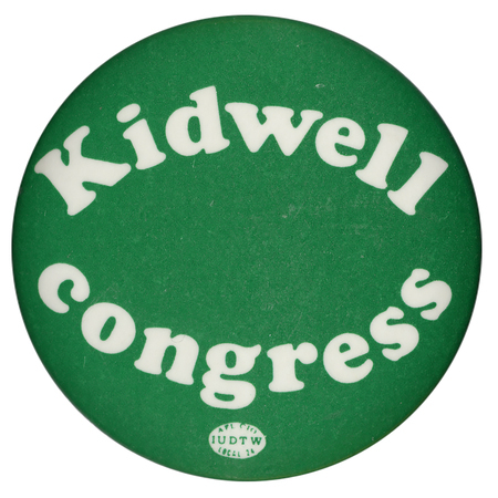 Round, green button with white text reading "Kidwell congress"