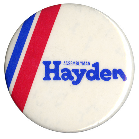 Round, white button with blue and red stripes along the left side. Blue text reads "ASSEMBLYMAN Hayden"