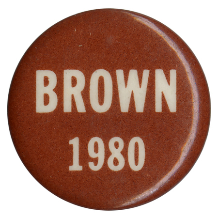 Round, brown button with white text reading "BROWN 1980"