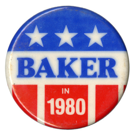 Round button with red, white, and blue stars and stripes decoration. Blue and white text reads "BAKER IN 1980"