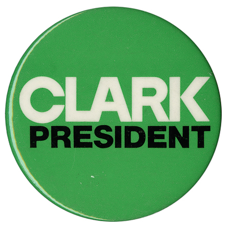 Round, green button with white and black text reading "CLARK PRESIDENT"