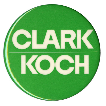 Round, green button with white text reading "CLARK KOCH"