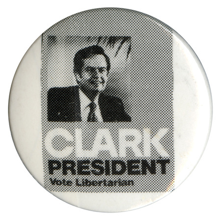 Round, white button with a square gray section containing a black and white photograph of Ed Clark. White and black text reads "CLARK PRESIDENT Vote Libertarian"