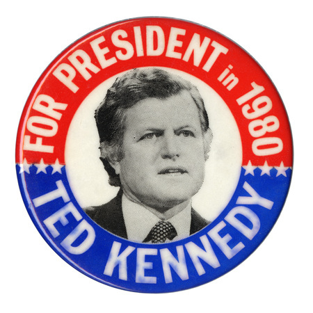 Round button with red and blue border and a black and white photograph of Ted Kennedy in the center. White text reads "FOR PRESIDENT in 1980 TED KENNEDY"