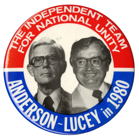 Round button with red and blue border and a black and white photographs of John Anderson and Patrick Lucey in the center. White text reads "THE INDEPENDENT TEAM FOR NATIONAL UNITY ANDERSON-LUCEY in 1980"