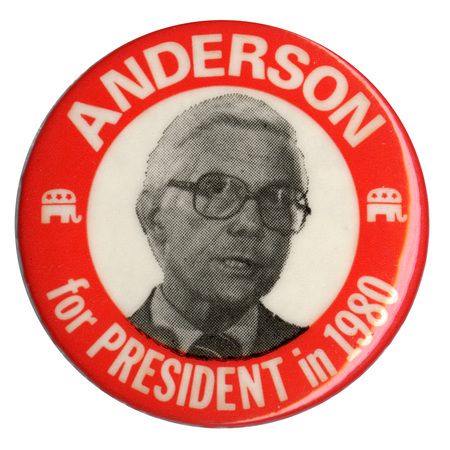Round button with a red border and a black and white photograph of John Anderson within a white circle in the middle, flanked by two drawings of the GOP elephant symbol. White text reads "ANDERSON for PRESIDENT in 1980"