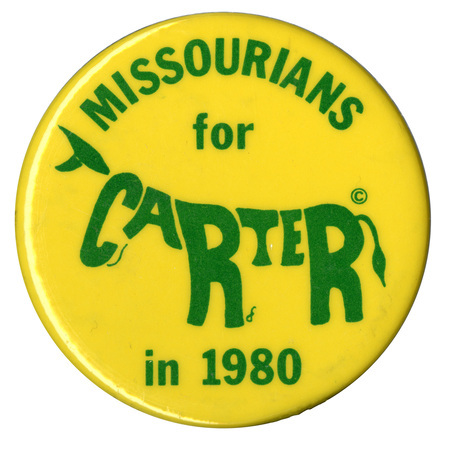Round, yellow button with green text reading "MISSOURIANS for CARTER in 1980." The letters in the word "CARTER" are formed in the shape of a donkey.