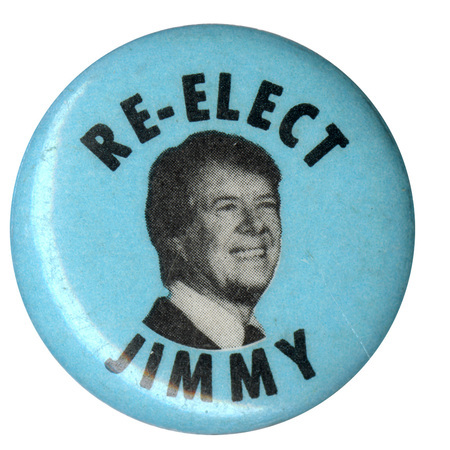 Round, blue button with a black and white photograph of Jimmy Carter. Black text reads "RE-ELECT JIMMY"