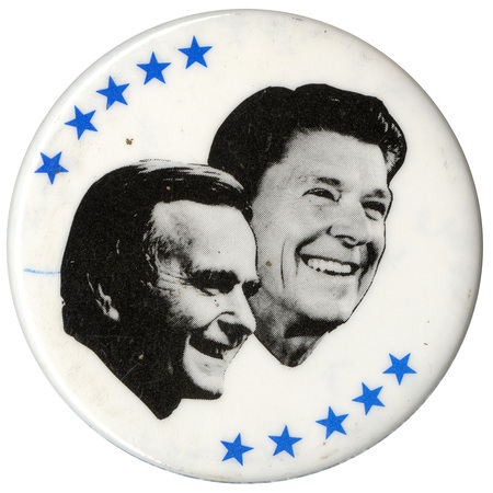 Round, white button with black and white photographs of George H. W. Bush and Ronald Reagan surrounded by blue stars.