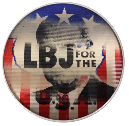 Round holographic button. One angle shows red, white, and blue flag decorations, the outline of the United States, and text reading "LBJ for the USA." The other angle shows an image of Lyndon B. Johnson.