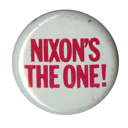 Round, white button with red text reading "Nixon's the one!"