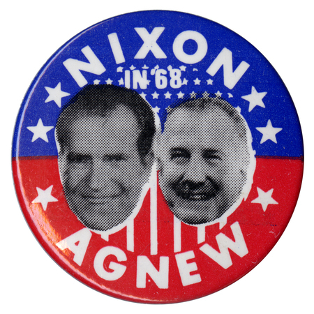 Round, blue and red button with portraits of Richard Nixon and Spiro Agnew and white stars and stripes. White text reads "Nixon in '68, Agnew."