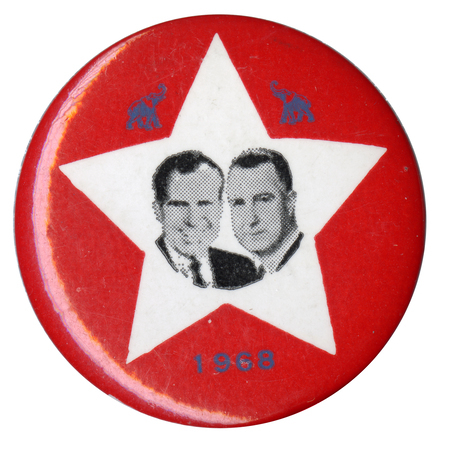 Round, red button with a white star containing portraits of Richard Nixon and Spiro Agnew and two black elephants. Black text reads "1968" 