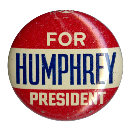 Round, red and white button with white and blue text reading "Humphrey for president."