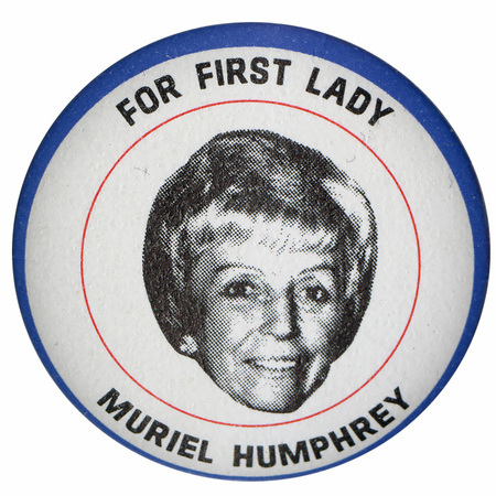 Round, white button with a black and white portrait of Muriel Humphrey surrounded by red and blue circular lines. Black text reads "For First Lady, Muriel Humphrey."