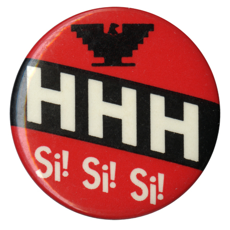 Round, red button with the blocky eagle symbol of the United Farm Workers in black and white text reading "HHH Si! Si! Si!"