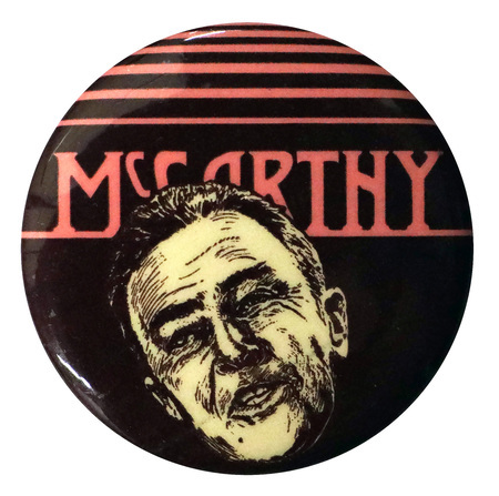 Round, black button with an illustration of Eugene McCarthy and red text reading "McCarthy."