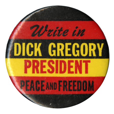 Round, red, black, and yellow button with text reading "Write in Dick Gregory President Peace and Freedom."
