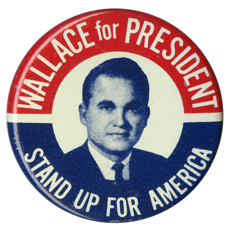 Round, white button with a portrait of George Wallace. Red and blue bands along the edge of the button contain white text reading "Wallace for President, Stand Up for America."