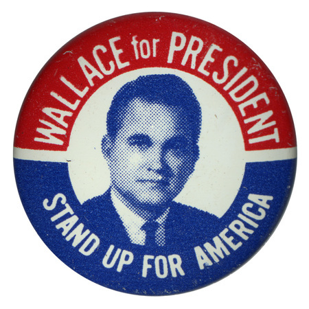 Round, white button with a portrait of George Wallace. Red and blue bands along the edge of the button contain white text reading "Wallace for President, Stand Up for America."