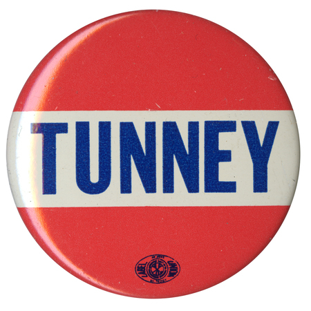 Round, red and white button with blue text reading "Tunney."