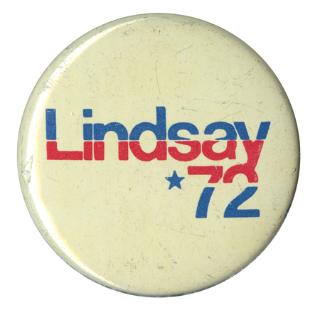 Round, off white button with red and blue text reading "Lindsay '72."