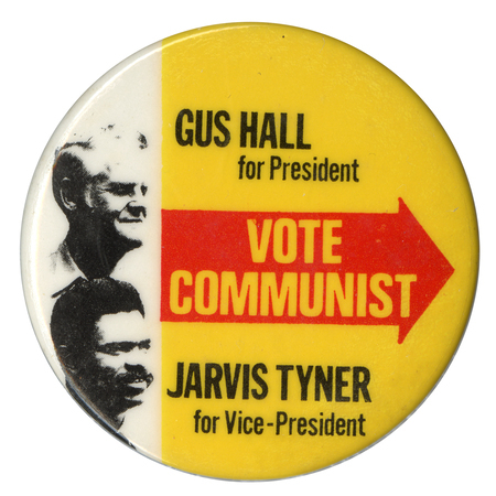 Round, white and yellow button with black and white portraits of Gus Hall and Jarvis Tyner and a large red arrow pointing to the right. Text reads "Gus Hall For President, Vote Communist, Jarvis Tyner for Vice-President."