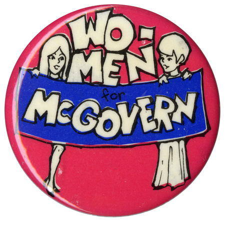 Round, red button with a line drawing of two people holding a blue banner. White, blocky text reads "WO-MEN for McGOVERN"