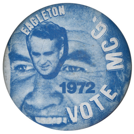 Round, blue button with a small portrait of Thomas Eagleton's head set against a larger portrait of George McGovern's face. White text around the edge reads "EAGLETON 1972 VOTE MC G."
