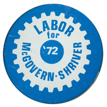 Round, blue button with a drawing of a white gear. Blue and white text reads "LABOR for McGOVERN-SHRIVER '72"