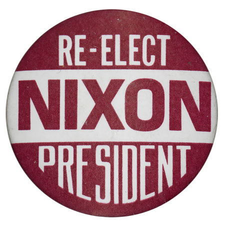 Round, red and white button with white and red text reading "RE-ELECT NIXON PRESIDENT"