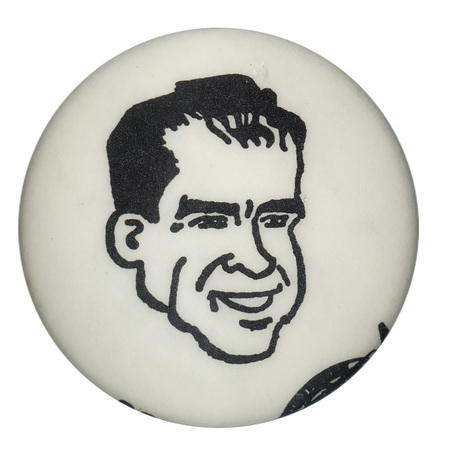 Round, white button with a black line drawing of Nixon's face.