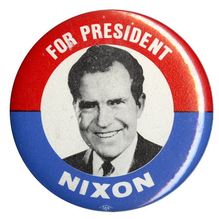 Round, red, white, and blue button with a black and white portrait of Richard Nixon. White text reads "FOR PRESIDENT NIXON"