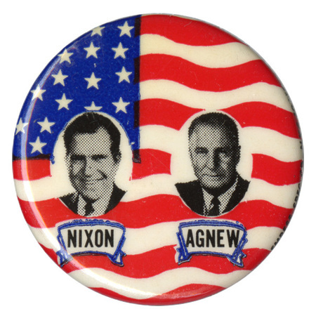 Round button with black and white portraits of Richard Nixon and Spiro Agnew against a red, white, and blue US flag. Black text below the portraits reads "NIXON AGNEW"
