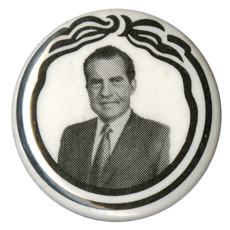 Round, white button with black stripe decorations and a black and white portrait of Richard Nixon.