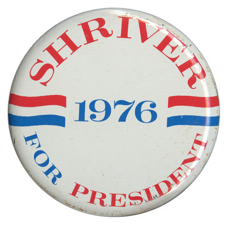 Round, white button with red, white, and blue stripe decorations. Blue and red text reads "SHRIVER 1976 FOR PRESIDENT"