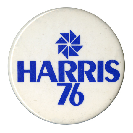 Round, white button with a drawing of a blue pinwheel and blue text reading "HARRIS 76"