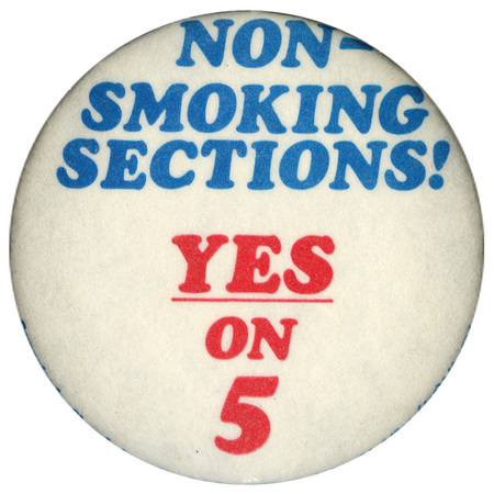 Round, white button with blue and red text reading" NON-SMOKING SECTIONS! YES ON 5"