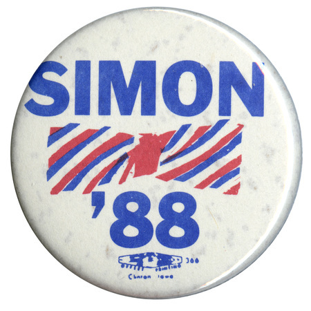 Round, white button with a drawing of a red and blue bowtie in the center. Blue text reads "SIMON '88"