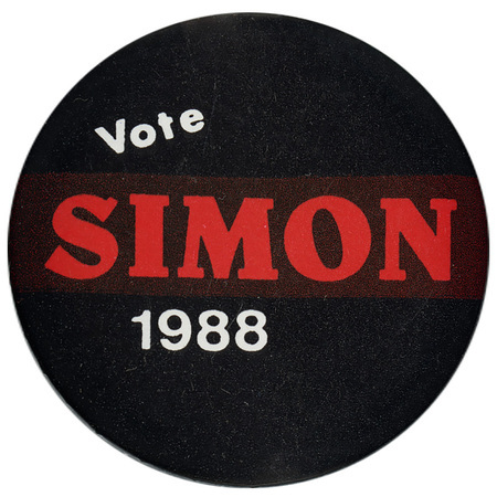 Round, black button with white and red text reading "Vote SIMON 1988"