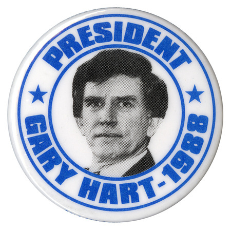 Round, white button with a black and white photograph of Gary Hart surrounded by blue text reading "PRESIDENT GARY HART - 1988"