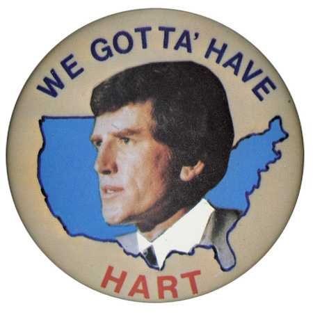 Round, beige button with a color photograph of Gary Hart within a blue outline of the United States. Blue and red text reads "WE GOTTA' HAVE HART"