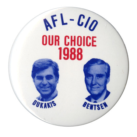 Round, white button with blue and white photographs of Michael Dukakis and Lloyd Bentsen, each with his name under his photograph. Blue and red text reads "AFL-CIO OUR CHOICE 1988"