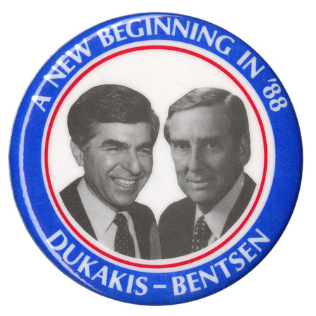 Round button with a blue border and black and white photographs of Michael Dukakis and Lloyd Bentsen within a white circle in the center. White text reads "A NEW BEGINNING IN '88 DUKAKIS-BENTSEN"
